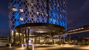 A modern hotel with a distinctive geometric facade and a circular entrance area.