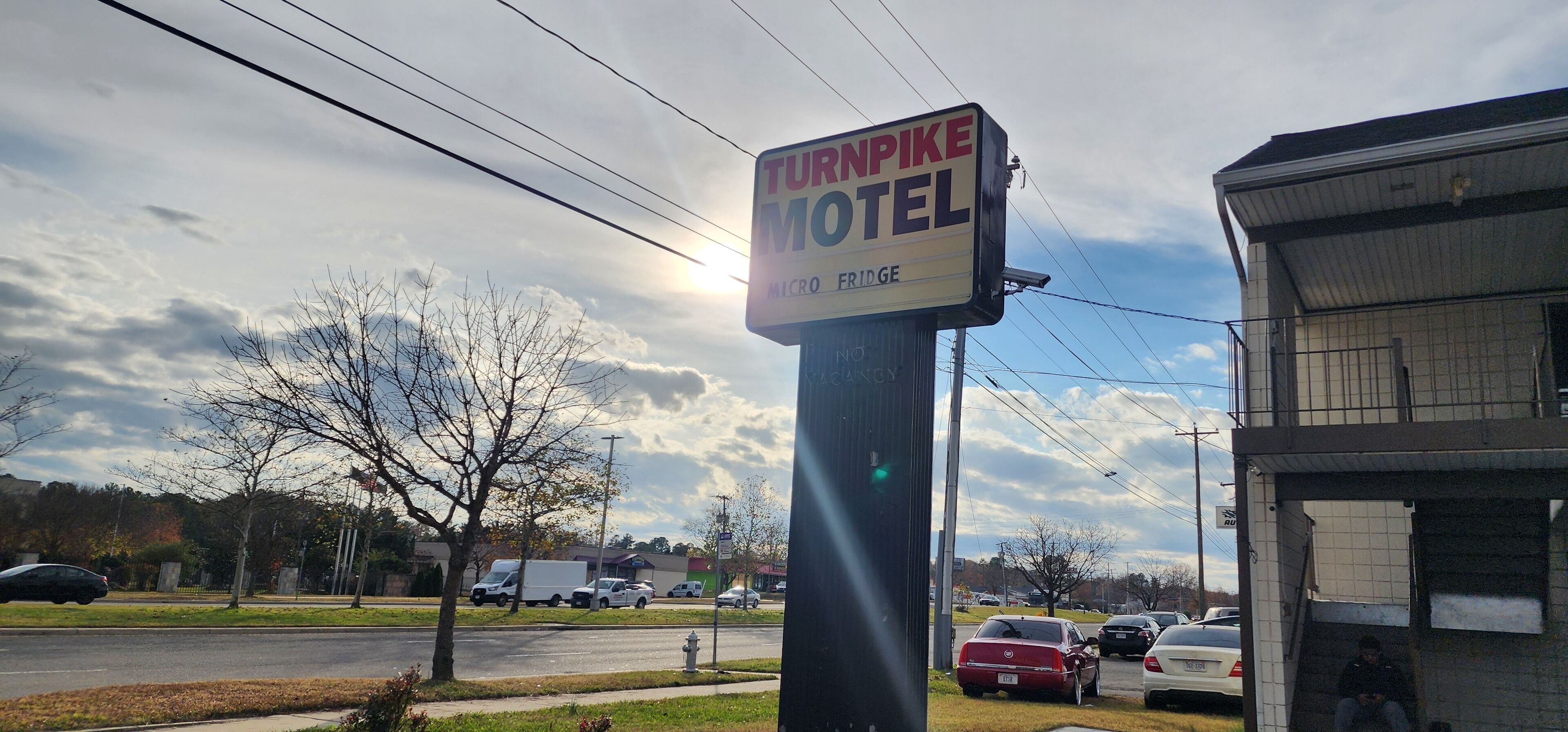 A motel sign with a 'Turnpike' nameplate and 'Macro' and 'Fridge' amenities.