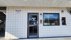 A building with a 'VACANCY' sign, a 'WARNING' sign, and a 'NO TRESPASSING' sign. - Turnpike Motel Richmond VA by Hotel O US 60 (Richmond)