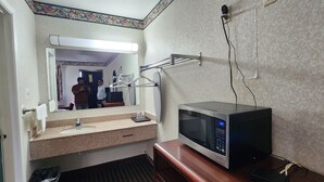 A bathroom with a sink, mirror, and a microwave. - Turnpike Motel Richmond VA by Hotel O US 60 (Richmond)