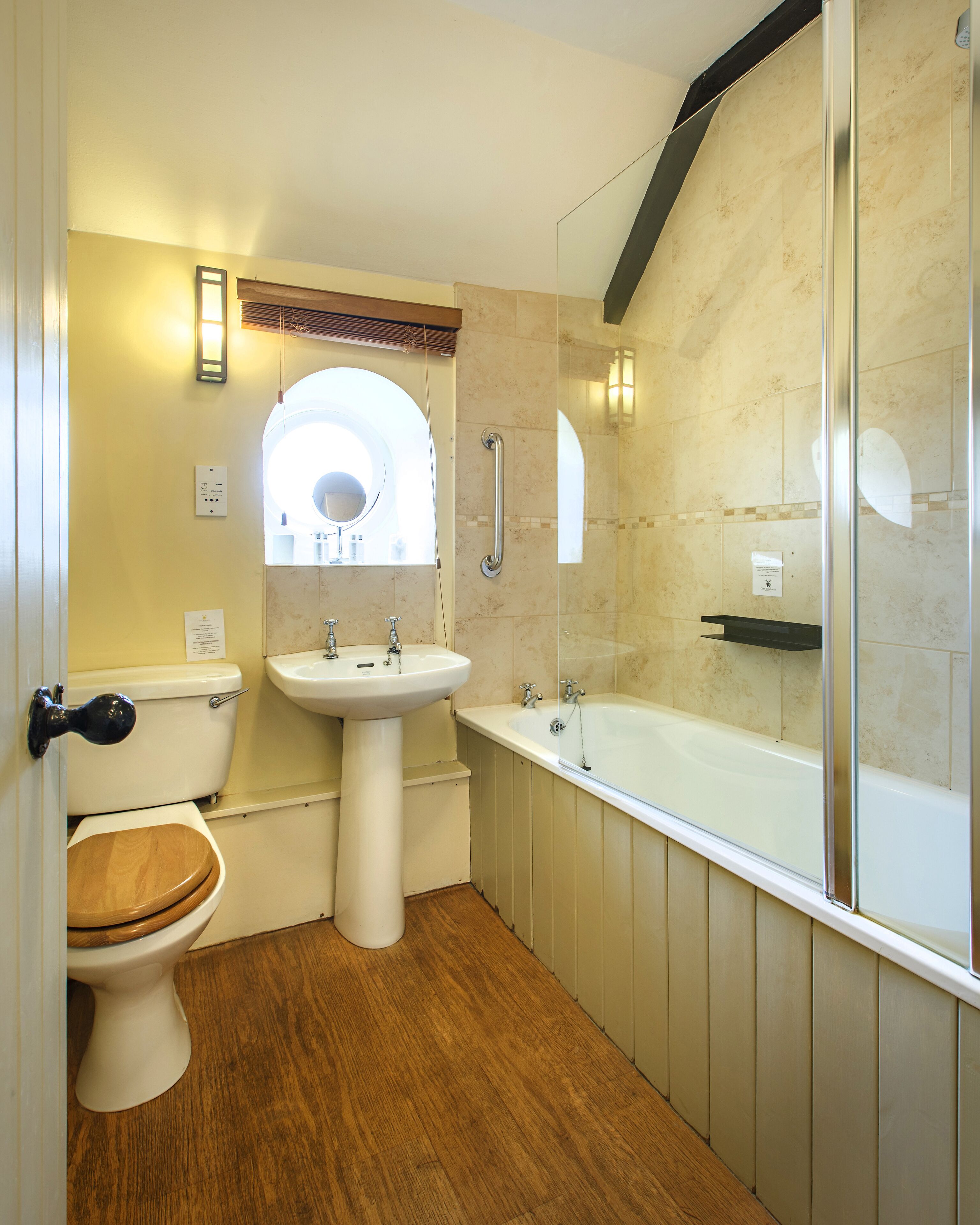 A bathroom with a toilet, sink, and bathtub.