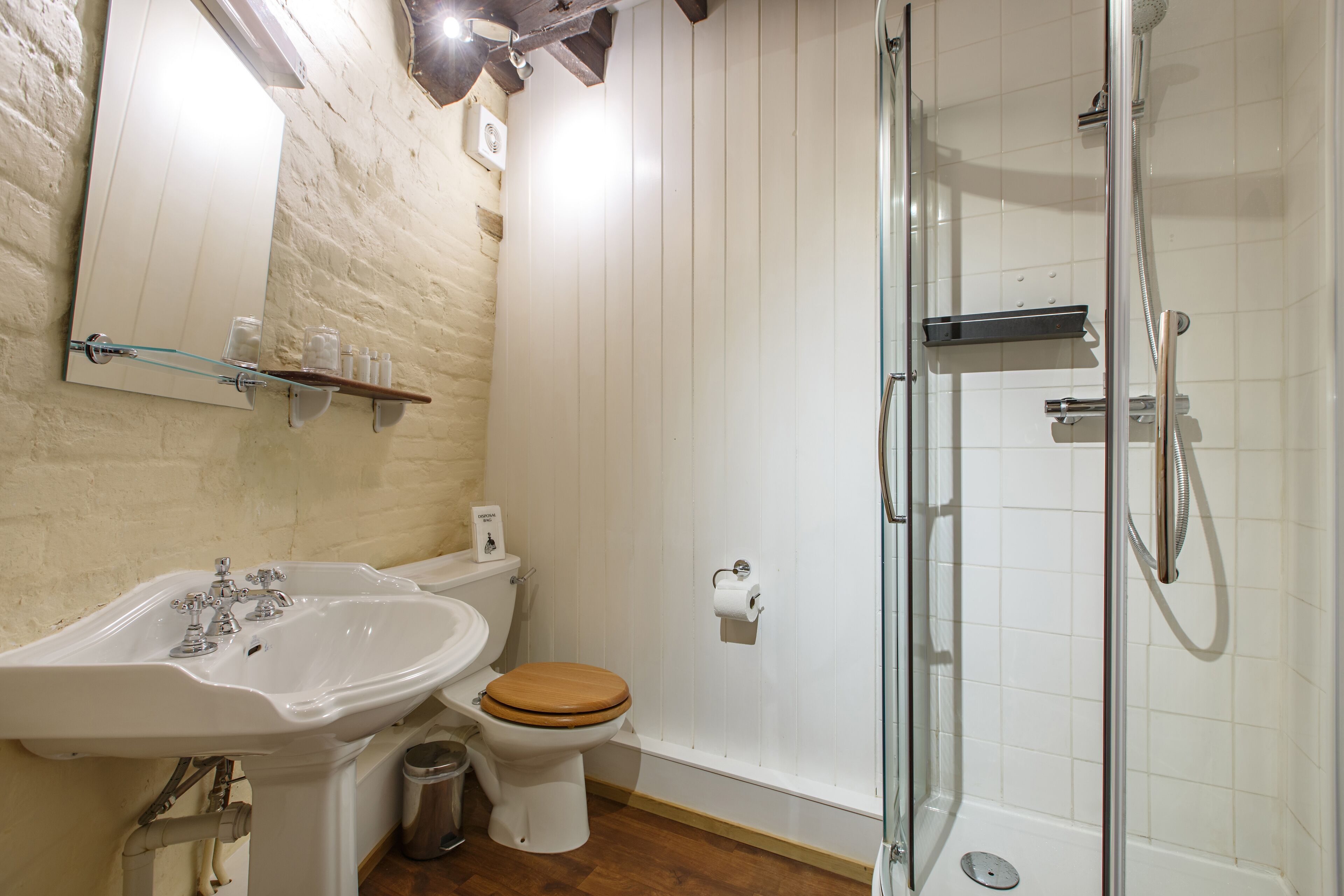 A bathroom with a sink, toilet, and shower.