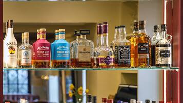 A liquor store shelf with various bottles of gin, whiskey, and other spirits.