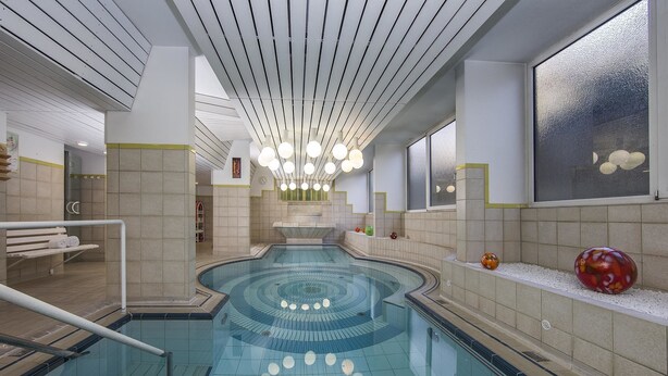 A modern indoor swimming pool with a central circular design, a ceiling with linear lighting fixtures, and a large window with a textured glass view. - Kurhotel Unter den Linden (Bad Fuessing)