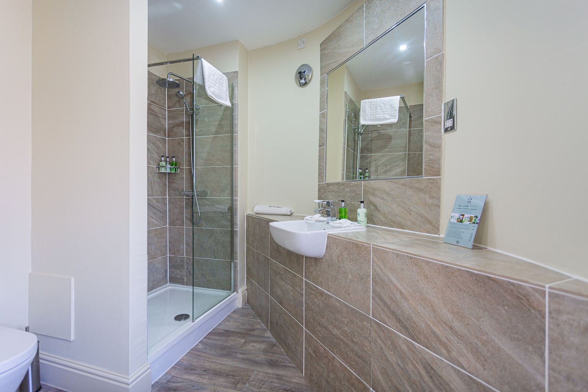 deluxe family room | bathroom | free toiletries, hair dryer, bathrobes, slippers