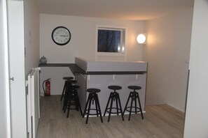 Prepare meals and dine in comfort with a central island and bar stools in this functional kitchen.