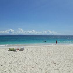 On the beach, white sand, sun-loungers, beach umbrellas