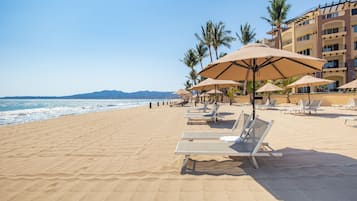 On the beach, sun loungers, beach umbrellas, beach towels