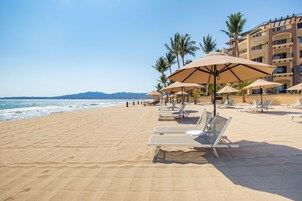On the beach, sun loungers, beach umbrellas, beach towels