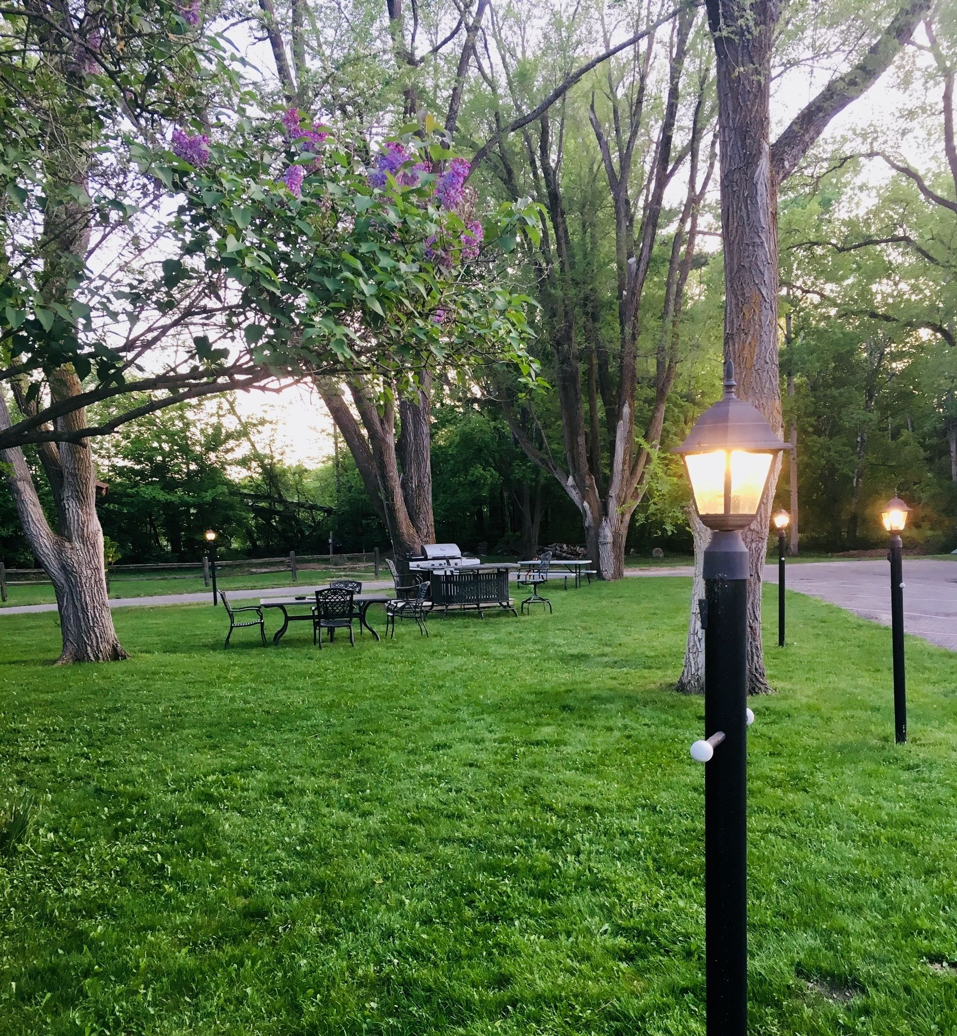 A park with a picnic area, benches, and a lamp post.