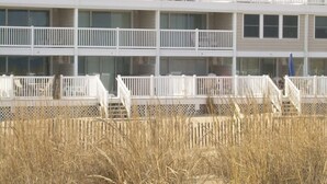 A multi-story building with balconies and a flat roof. - Ocean Colony 11, direct ocean front townhouse at 47th street (Ocean City)