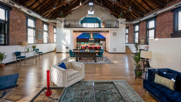 A spacious loft with high ceilings, exposed wooden beams, and large windows. - Luxurious, Converted Church Ideal for Large Groups near RiNo District, Sleeps 22 (Denver)
