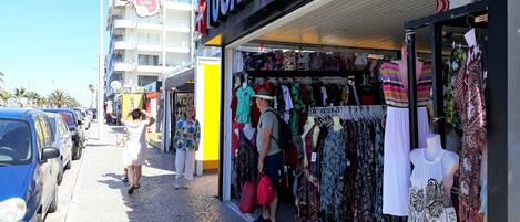 A clothing store with a variety of garments on display.