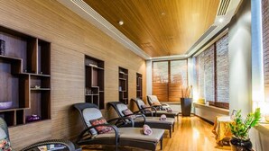 A spa room with wooden walls, multiple seating areas, and large windows. - Apartment Two Weeks Right of Use at Radisson Blu Resort & Spa, Golden Sands (L/o Mellieha)