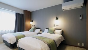 A hotel room with two beds, a large window with curtains, a wall-mounted air conditioner, and a bedside table with a lamp. - Shigakogen Hotel Ichibokaku (Yamanouchi)