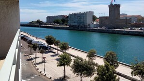 A coastal cityscape with a prominent tower, a promenade, and a view of the sea. - Comfortable T2 near beach, 4 ppl, elevator (Les Sables-d'Olonne)