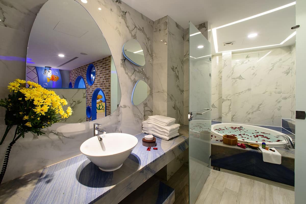 the bottom of the sea themed family room | premium bedding, minibar, desk, blackout curtains