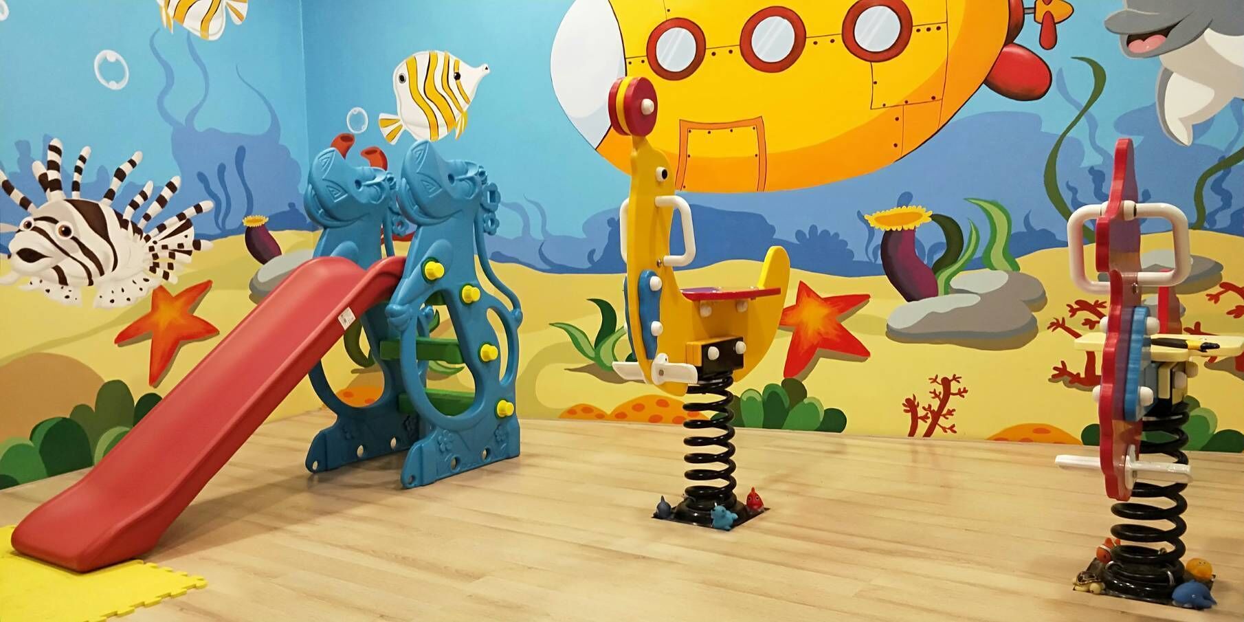 the bottom of the sea themed family room | premium bedding, minibar, desk, blackout curtains