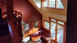 A high-ceilinged room with a sloped ceiling, large windows, a built-in bench, and a radiator. - The Trail's Edge / "Captain's Quarters" Is A Gorgeous Retreat, In Any Season.  (Duluth)