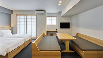 A modern hotel room with a bed, a desk, and a bench.