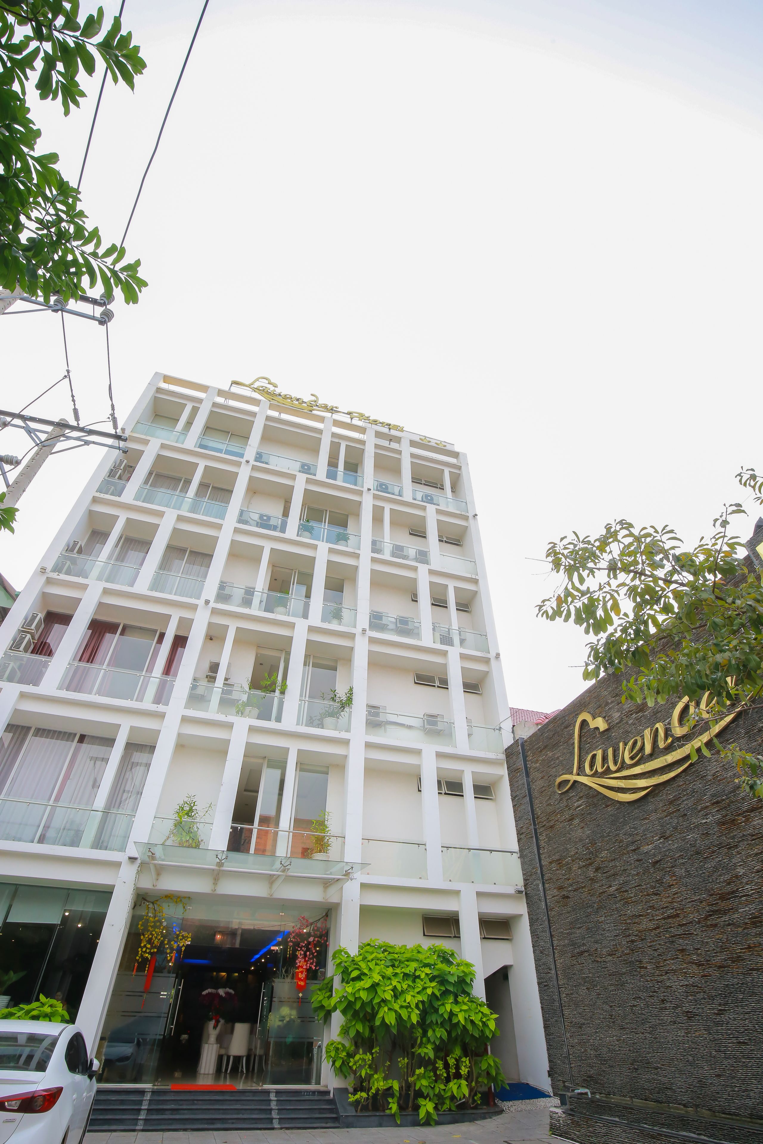 A multi-story hotel with balconies, a glass entrance, and a sign reading "Lavender."