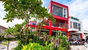 Un edificio rojo y blanco con un letrero que dice "Mokola".