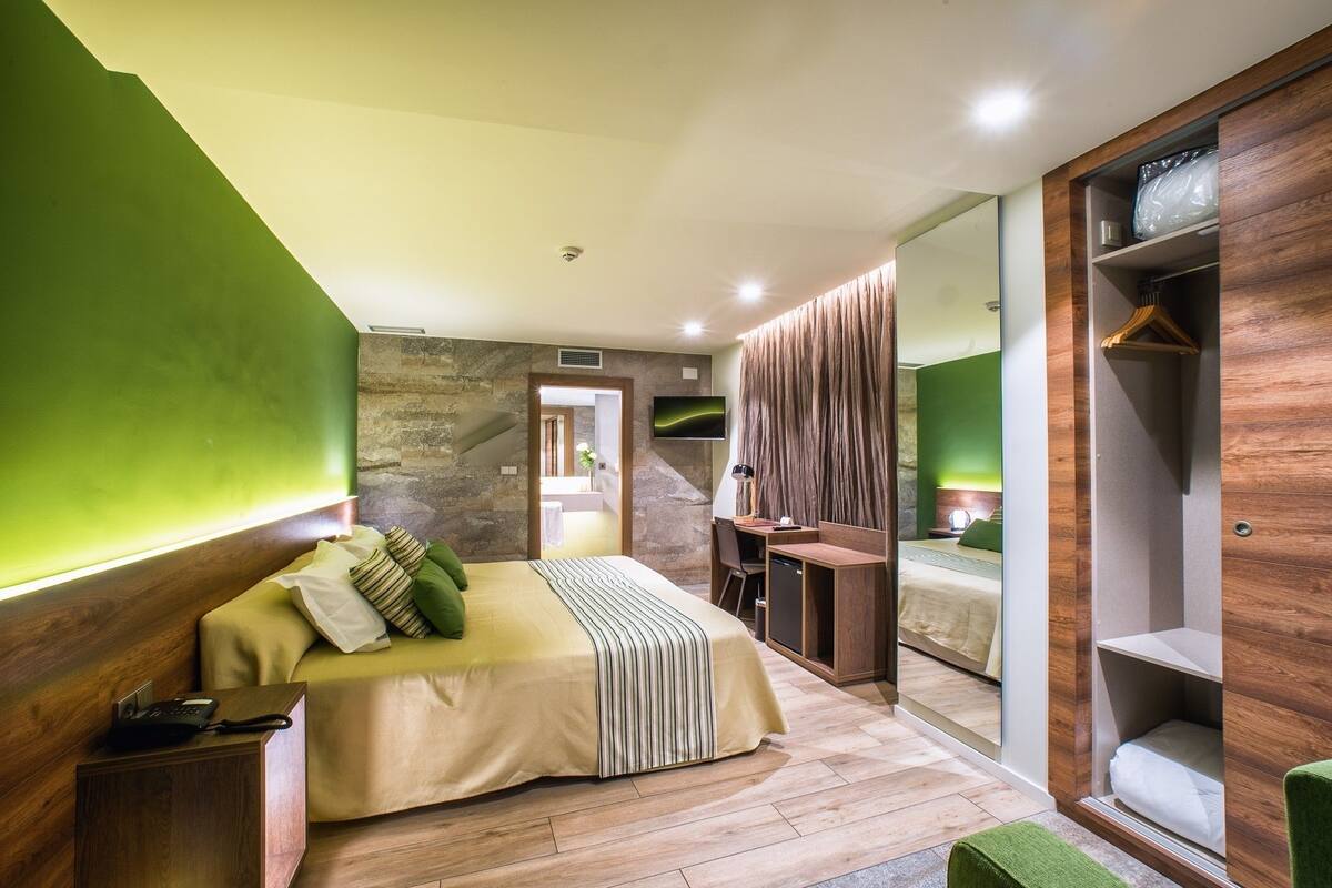 Une chambre à coucher moderne avec un lit, un bureau et une armoire.