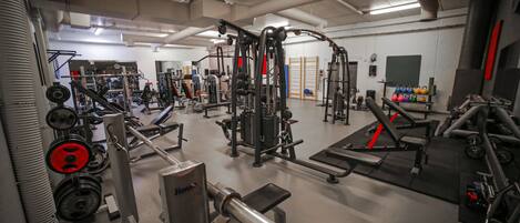 A gym with various exercise equipment, including weight machines and free weights.