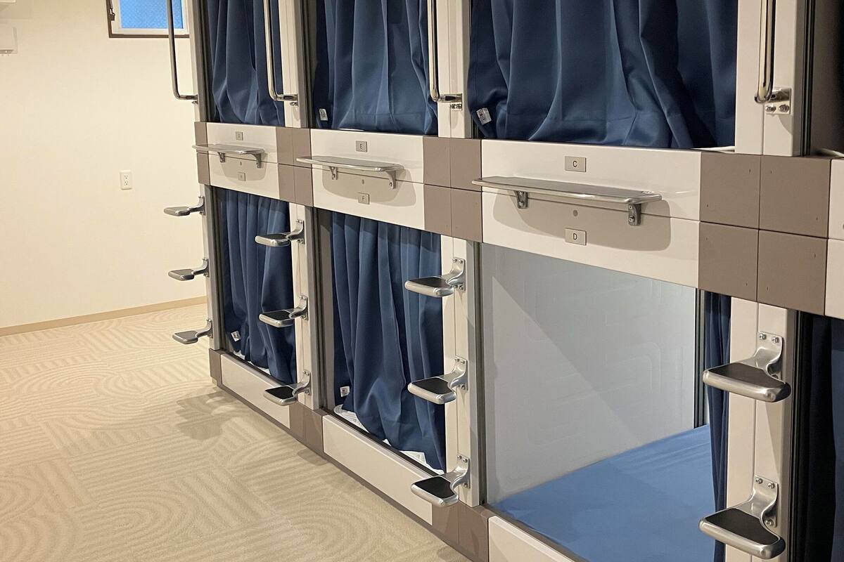 Una fila de habitaciones privadas con cortinas individuales y manijas de metal.