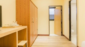 A narrow hallway with wooden cabinets and a wooden counter. - My Living Place Nathon (Koh Samui)