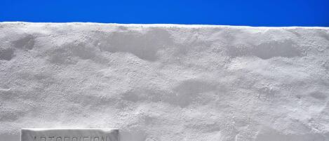 A sign on a snow-covered surface with the text "APTONOIEION" and "IAK A. KAAOYMENOY".