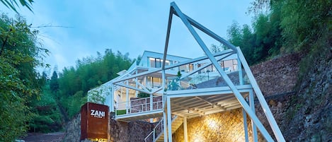 A modern, multi-level building with a stone facade and a prominent entrance labeled "ZAN!"
