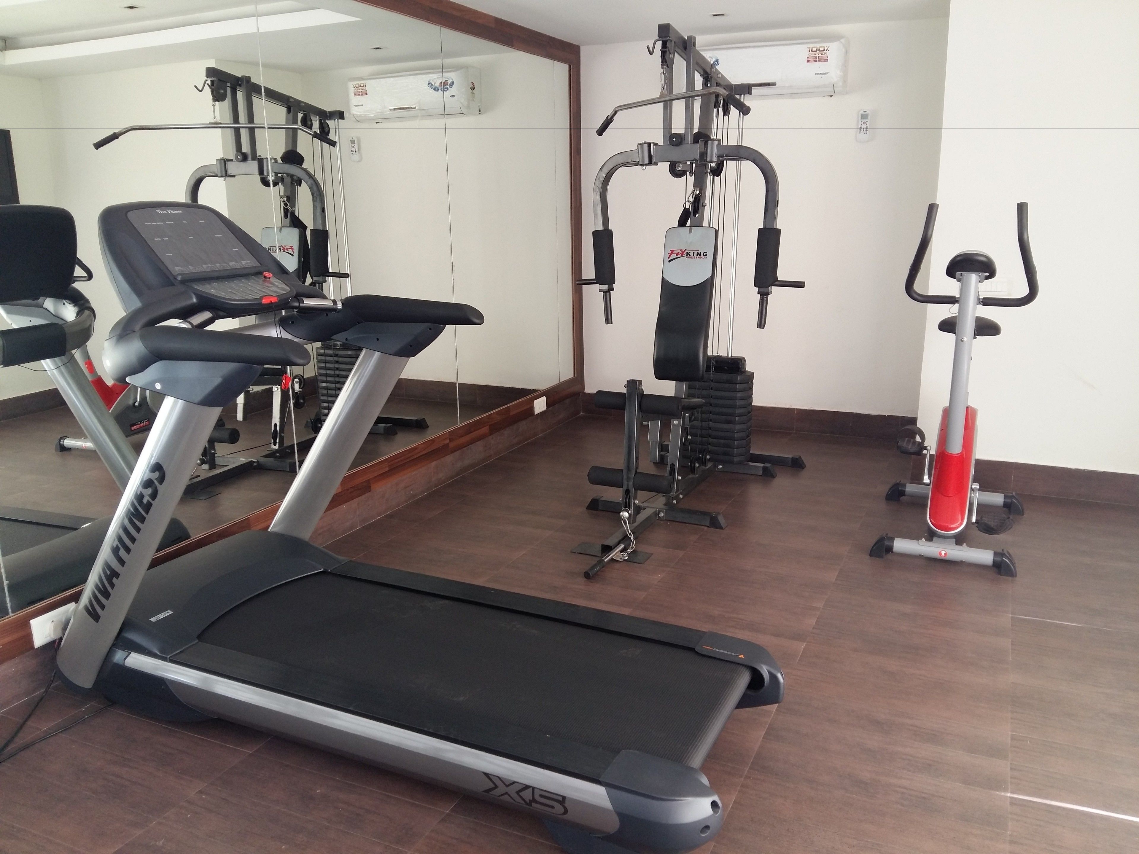 A gym with treadmills, a stationary bike, and weight machines.