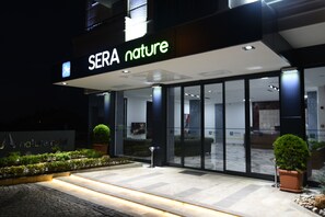 A hotel entrance with a sign reading "SERA nature" and a well-lit pathway leading to the entrance. - Sera Nature Hotel (Akçaabat)