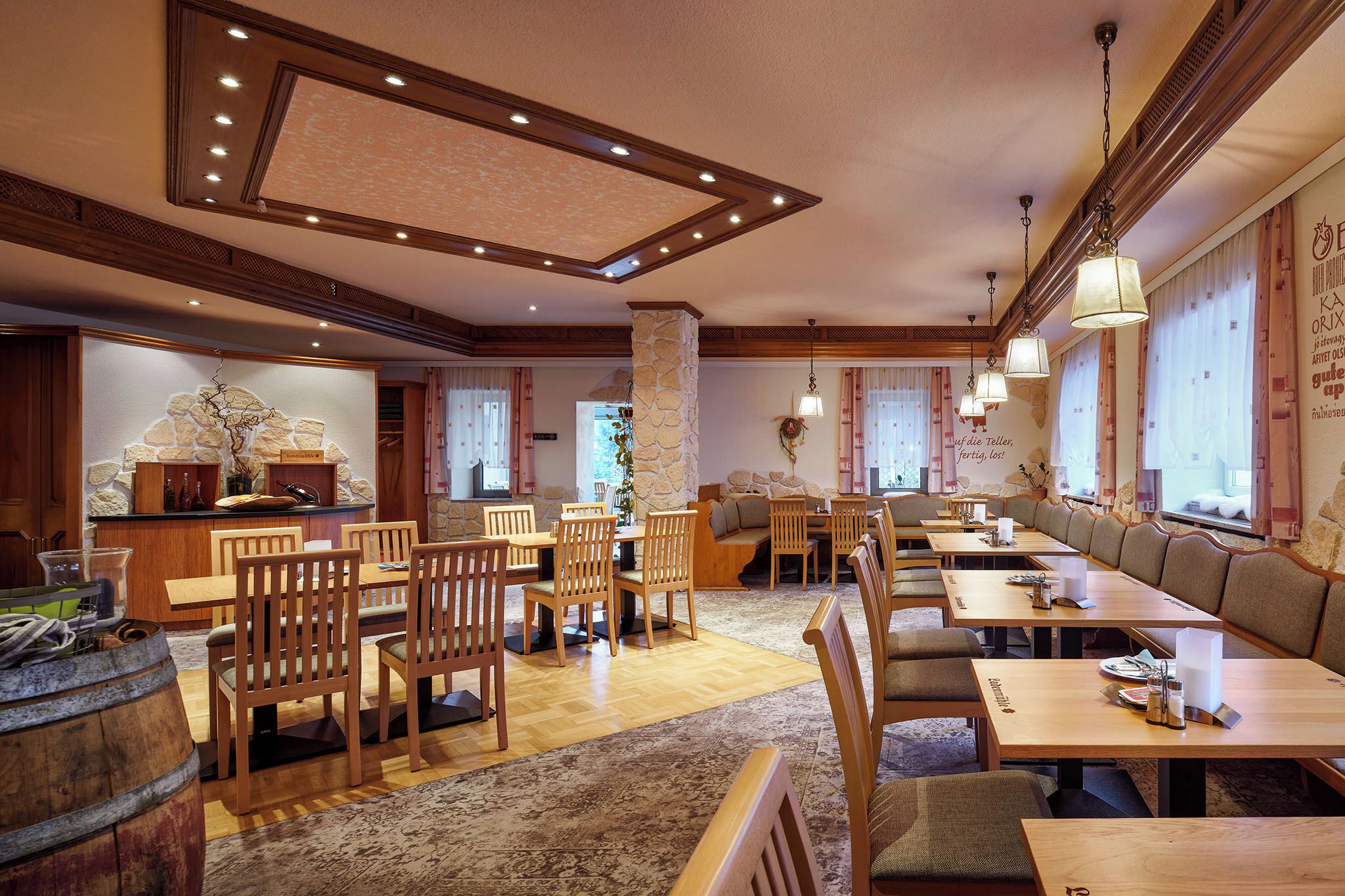 A restaurant with wooden furniture, stone accents, and a cozy atmosphere.