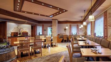 A restaurant with wooden furniture, stone accents, and a cozy atmosphere.
