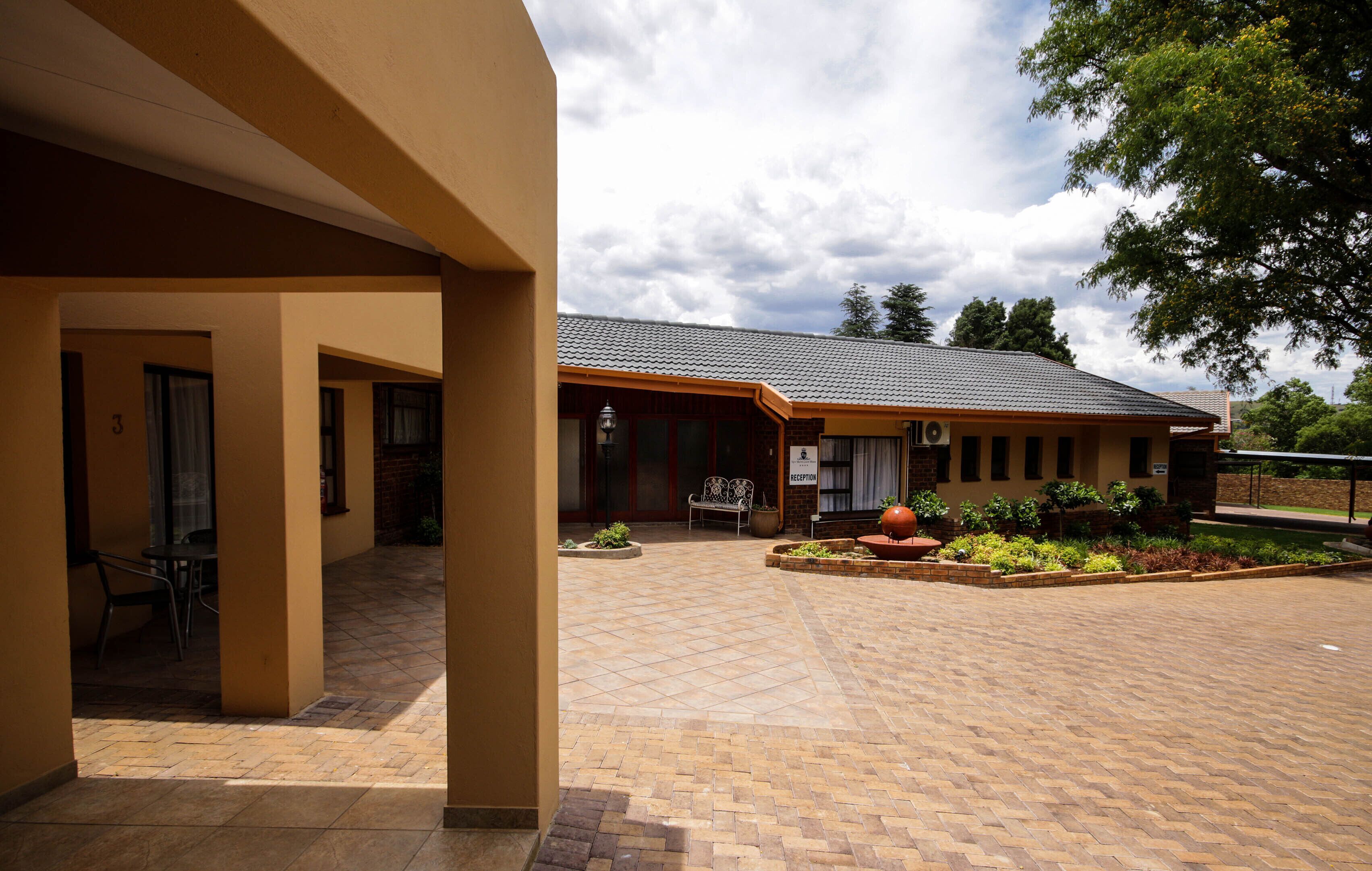 A building with a tiled patio, a reception desk, and a bench.