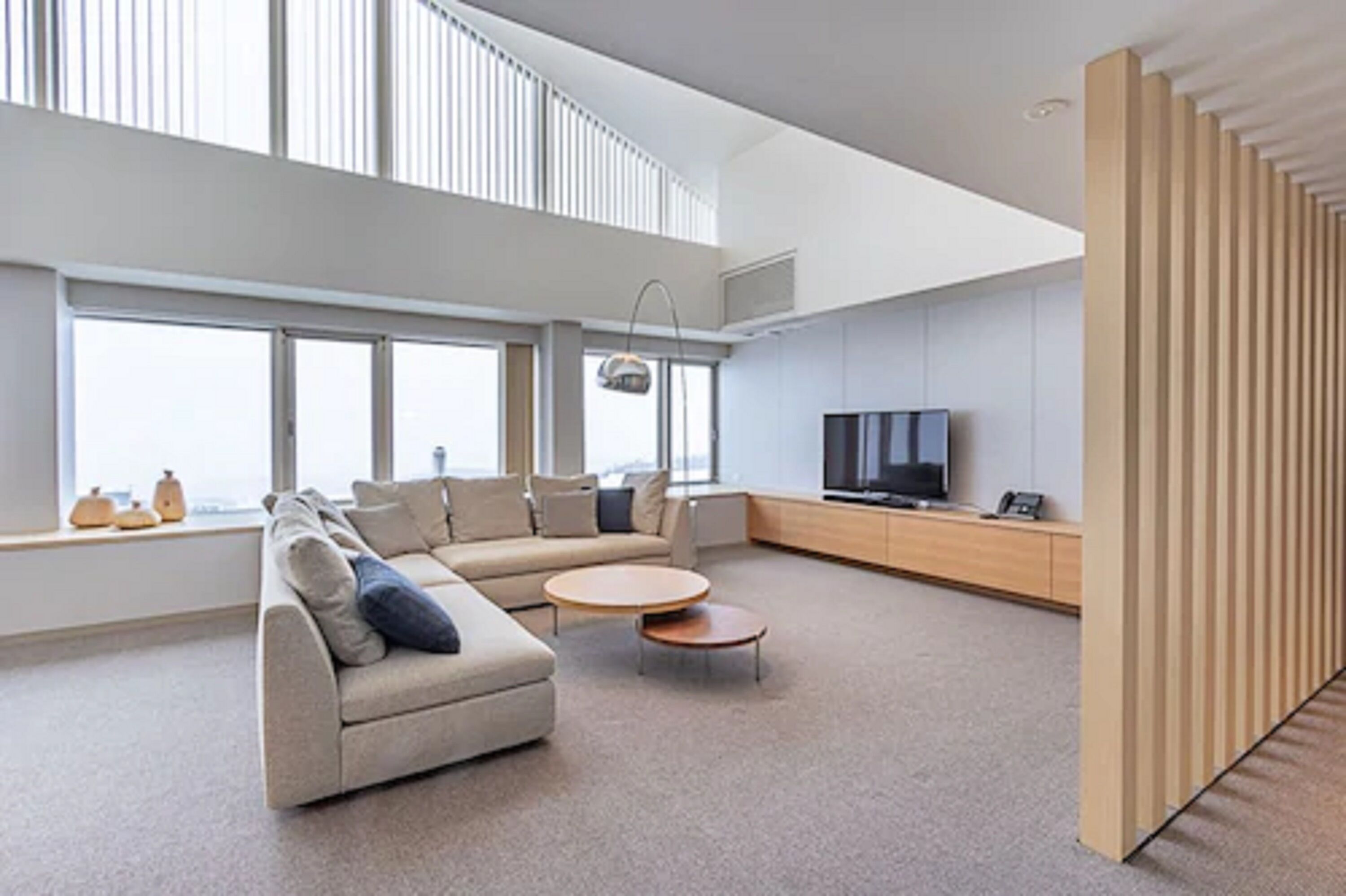 A modern living room with a sofa, coffee table, and TV.