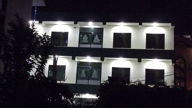 A multi-story building with illuminated windows and a central entrance. - Asian Himalaya Home Stay (Kathmandu)