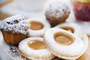 En tallrik med bakverk, pudrade med florsocker och med en tydlig fyllning.