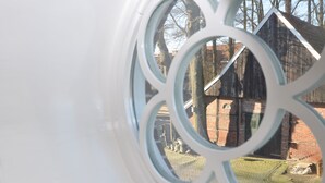 Una ventana con un marco metálico decorativo.