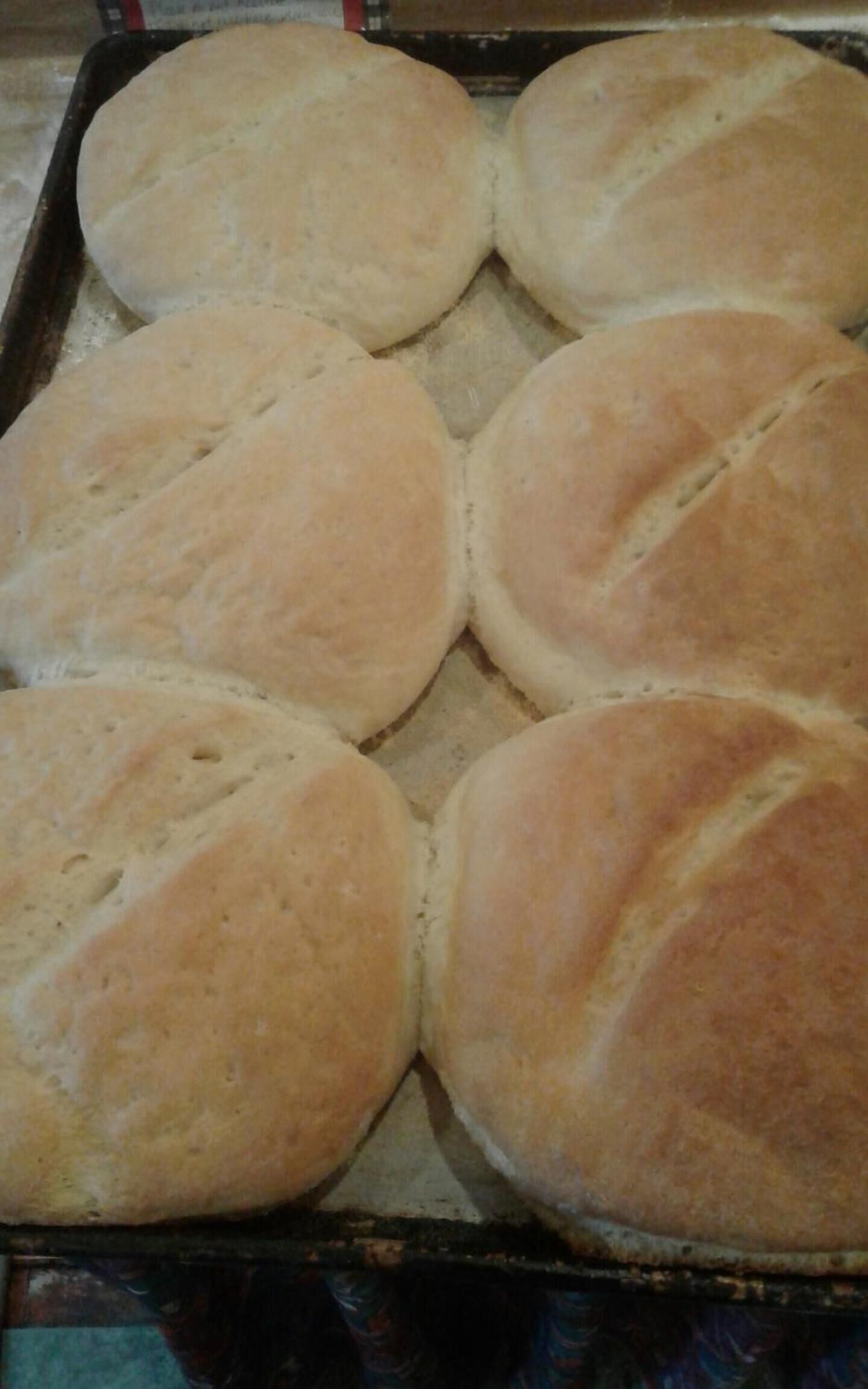 A tray of freshly baked bread rolls.