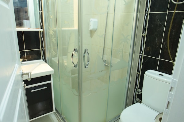 Shower, hair dryer, slippers, towels