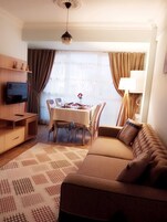 Deluxe Apartment, 1 Bedroom | Living room | LCD TV