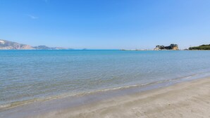 A beach with clear water and distant mountains. - Nel Mare Studios (Zakynthos)