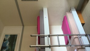 A bunk bed with a metal ladder, a painting on the wall, and a wooden floor. - Auberge Riva Bella - Hostel (Le Touquet-Paris-Plage)