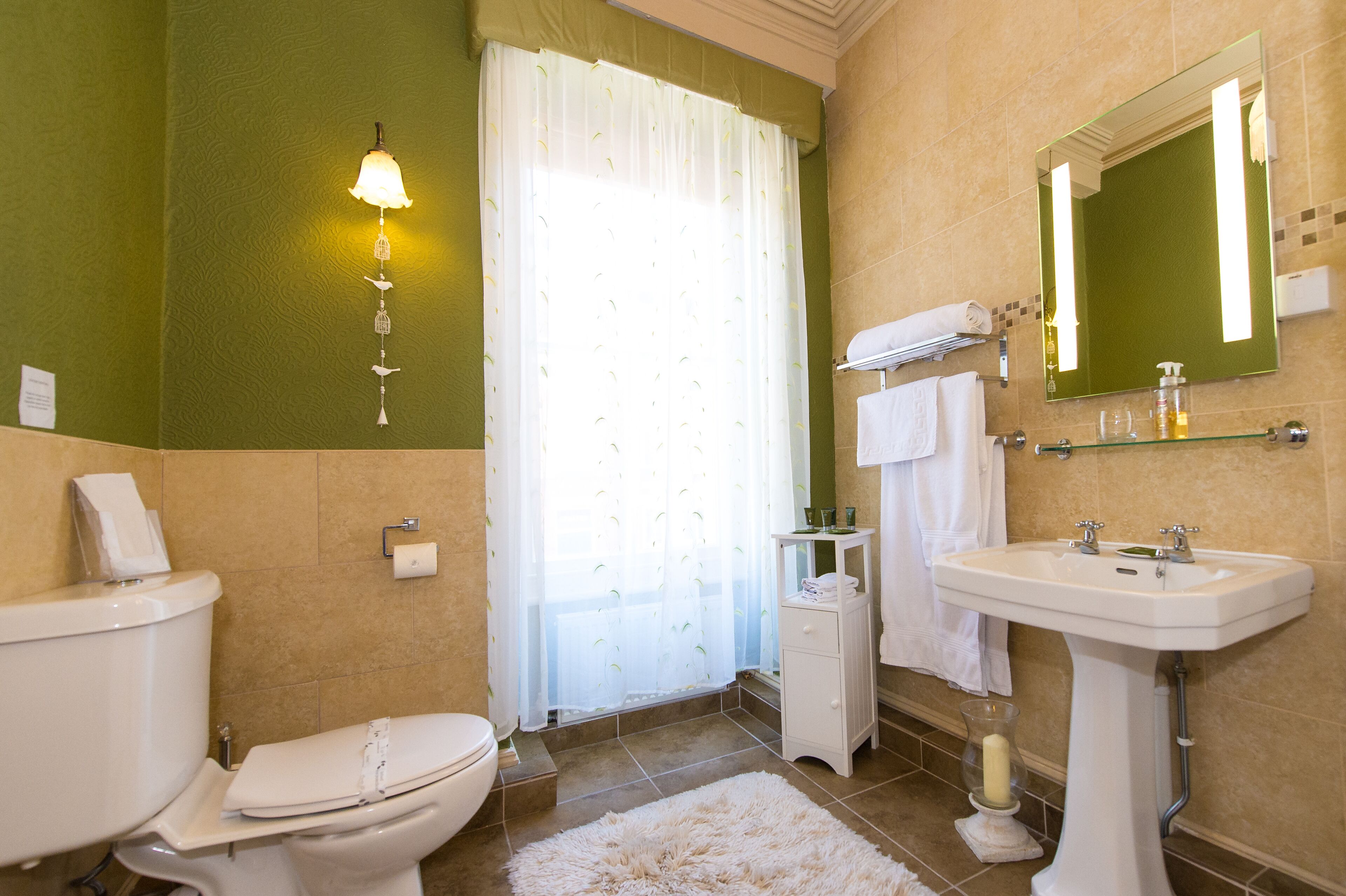 A bathroom with a toilet, sink, and shower curtain.