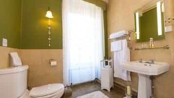 A bathroom with a toilet, sink, and shower curtain.