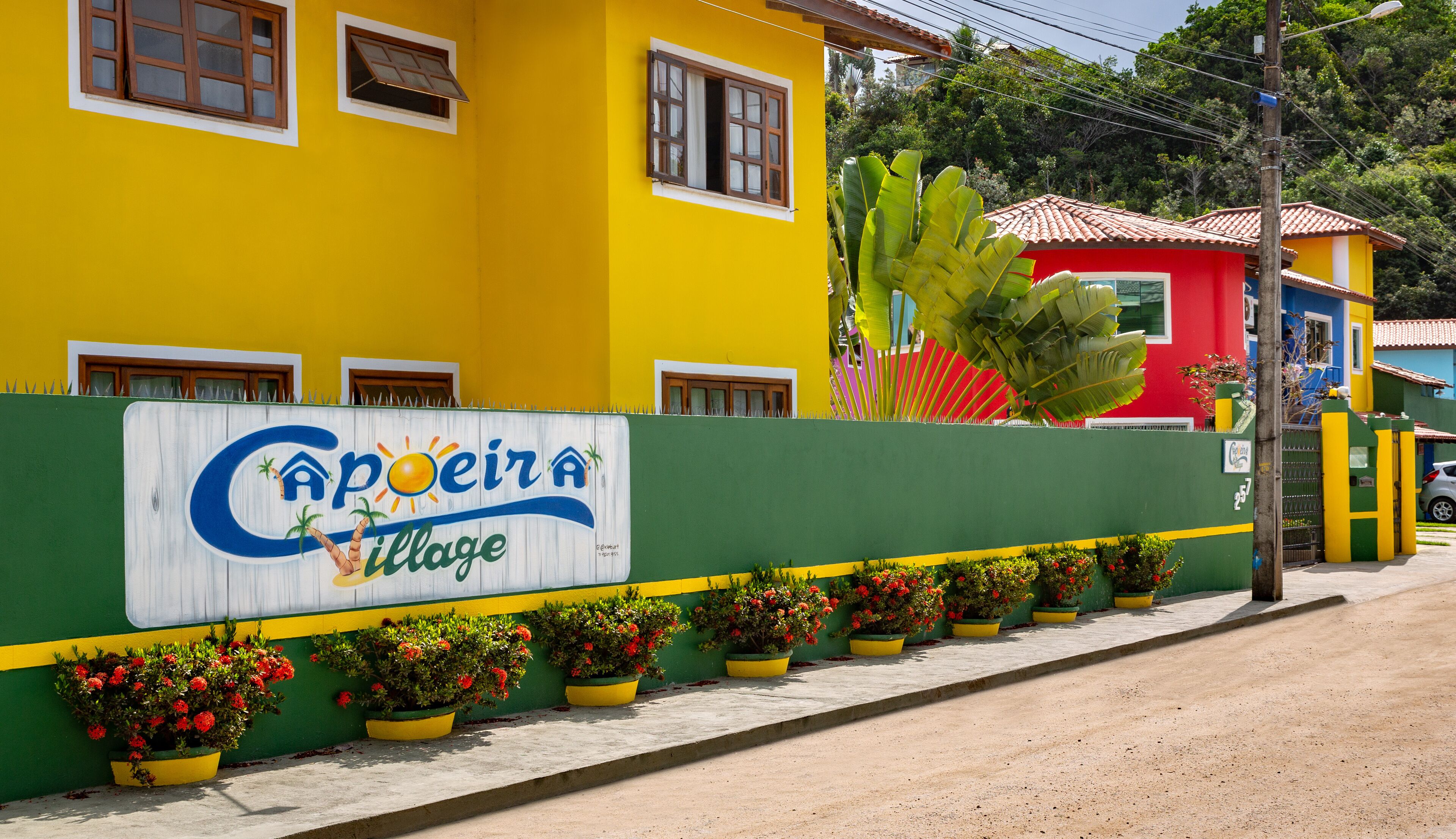 A colorful building with a sign reading "Capoeira Village".