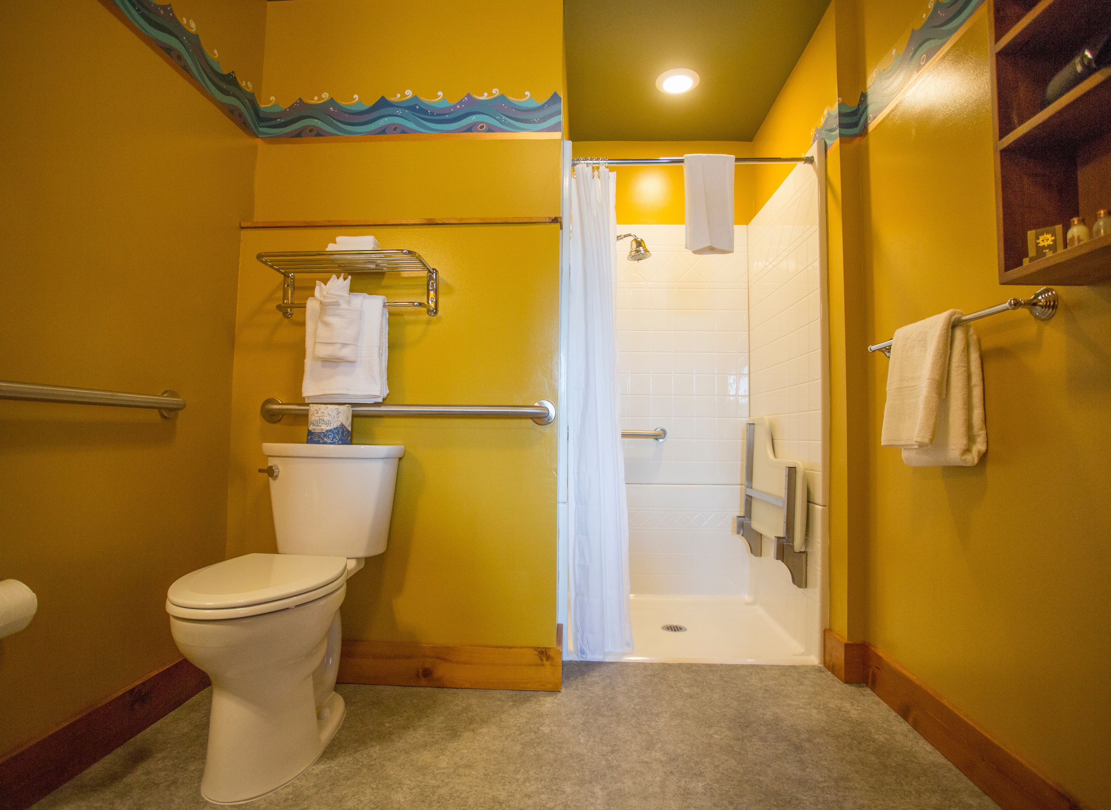 A bathroom with a toilet, a shower, and a towel rack.
